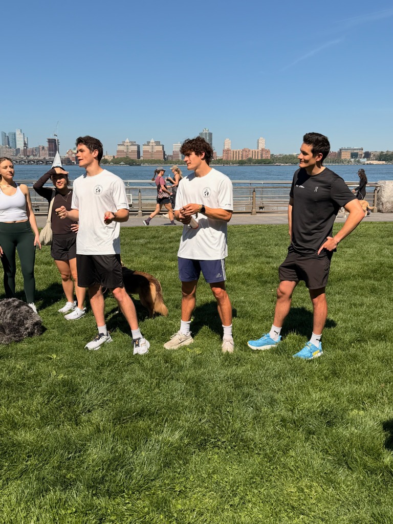 TCK Run Club members chatting at the waterfront pier